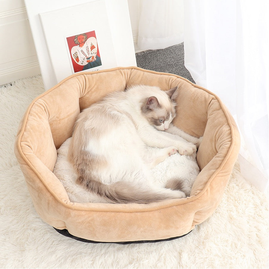 Cat sleeping comfortably in a luxury plush pet bed made of soft imitation suede, ideal for cats and small dogs